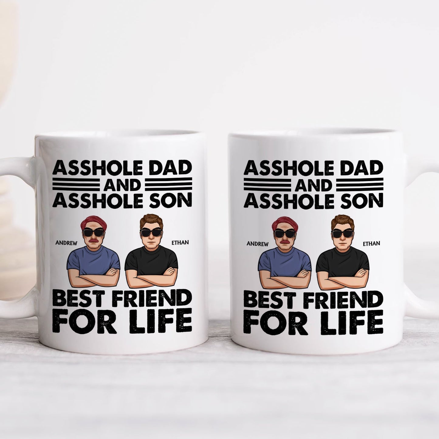Pair of white ceramic mugs with cartoon dad and son Andrew and Ethan featuring asshole dad and son gift best friend for life