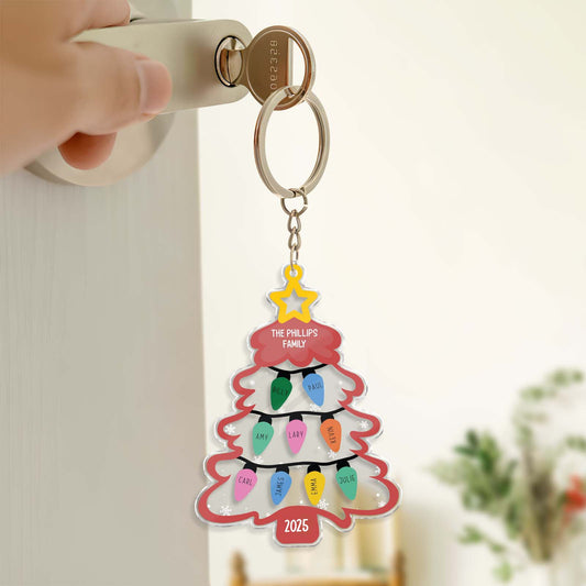 Personalized Christmas keychain shaped like a tree with family names and colorful ornaments