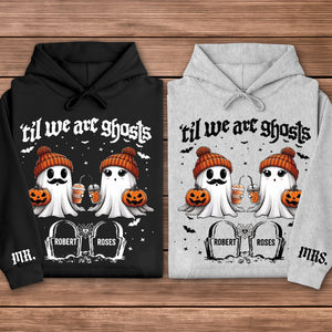 Black and gray hoodies personalized Halloween couple shirt featuring two cute ghosts in orange beanies holding pumpkins and drinks