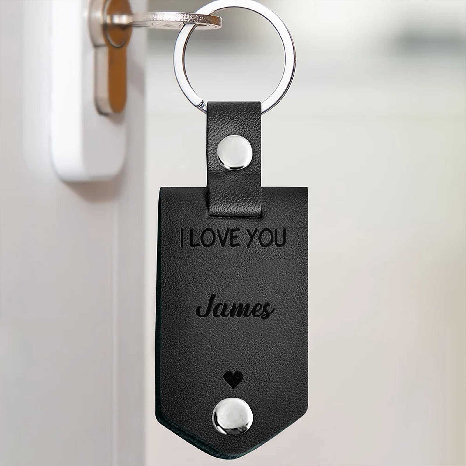 Personalized black leather keychain engraved with I love you James, a custom couple keychain gift