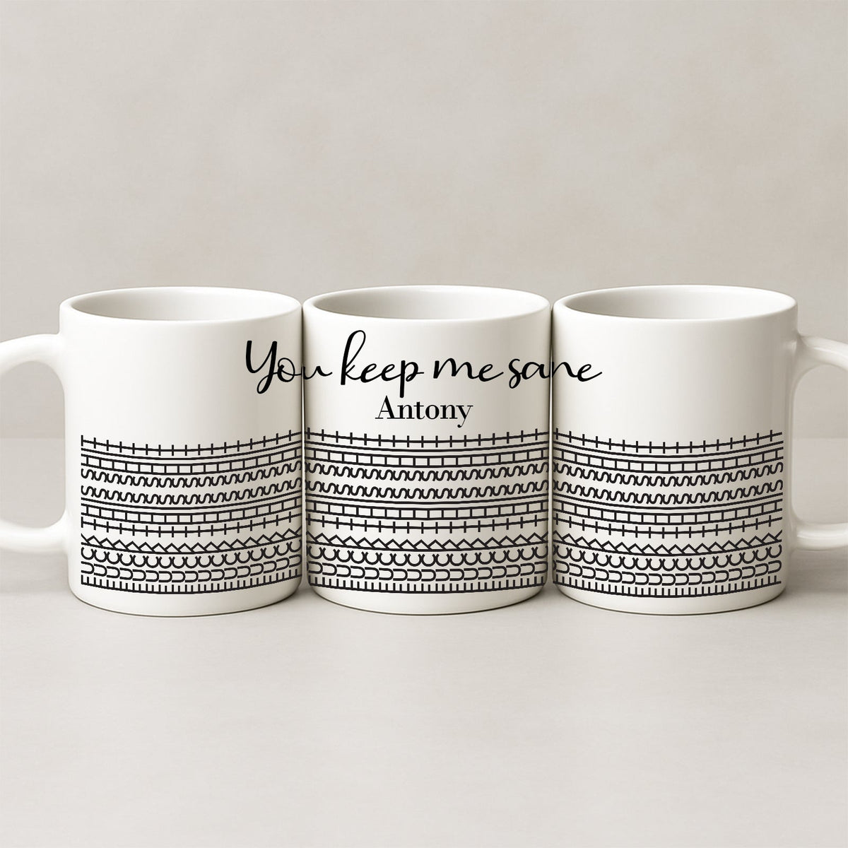 Three white ceramic personalized 'You Keep Me Sane' mug set with black geometric pattern and name Antony