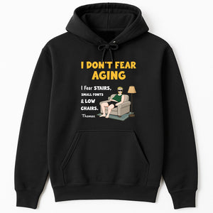 365Gifty black hoodie with I dont fear aging graphic featuring seated man and lamp personalized retirement shirt