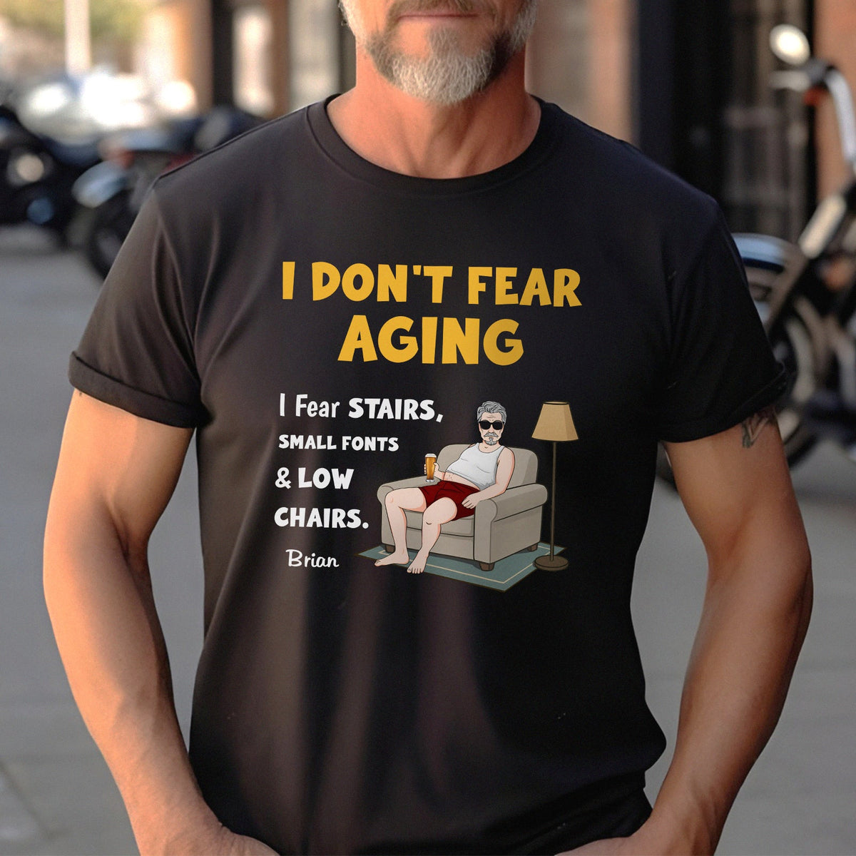 Black personalized retirement shirt reading I DONT FEAR AGING with cartoon man in chair holding drink