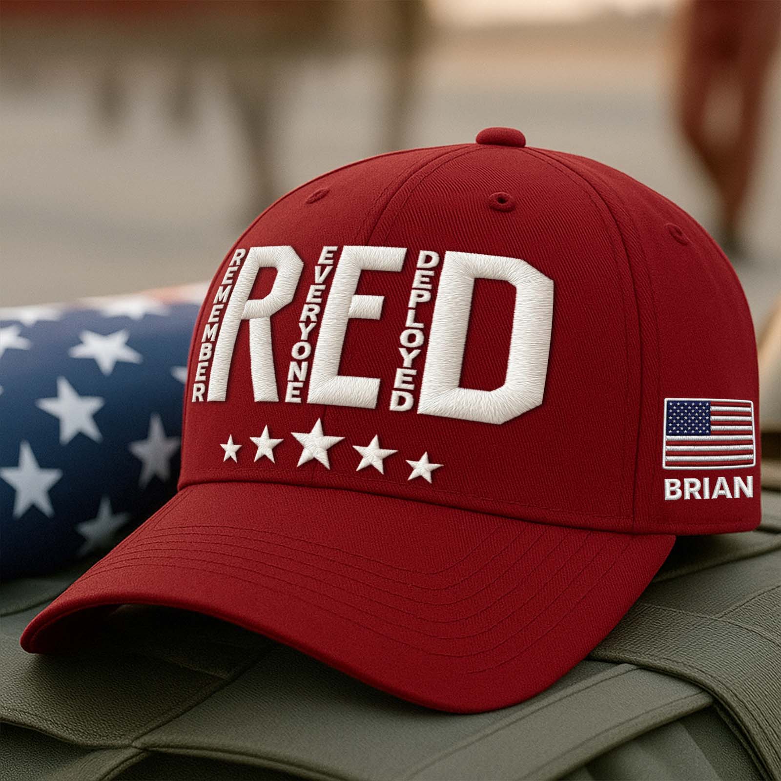 Embroidered Remember Everyone Deployed cap in red with white lettering and American flag detail