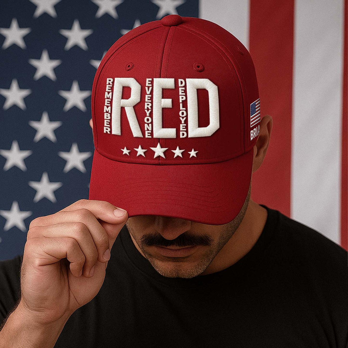 Embroidered Remember Everyone Deployed cap in red with a patriotic design and adjustable fit