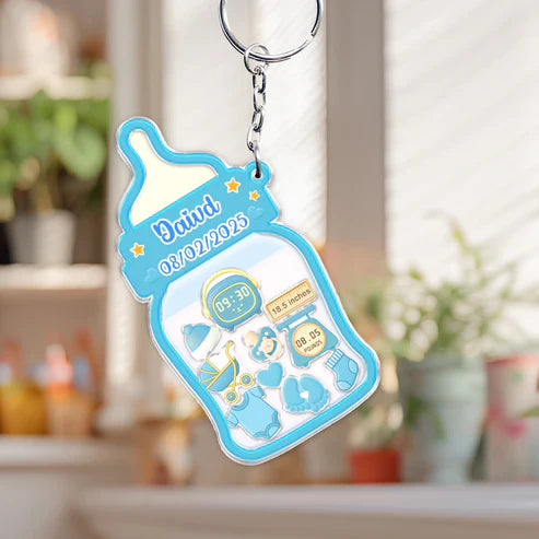 Family keepsake baby announcement keychain in blue featuring a baby bottle design with birth details
