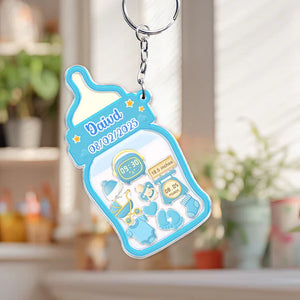 Family keepsake baby announcement keychain in blue featuring a baby bottle design with birth details