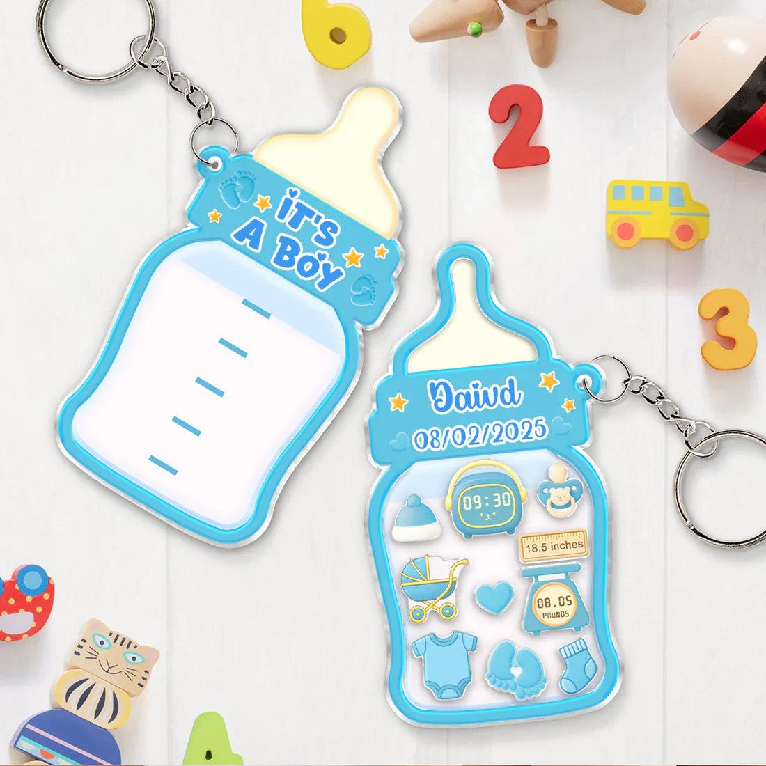 Family keepsake baby announcement keychain in blue with bottle design celebrating new arrival