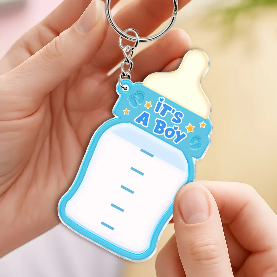 Colorful family keepsake baby announcement keychain shaped like a baby bottle saying it's a boy