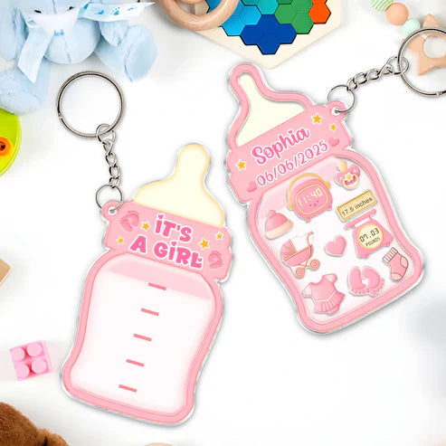 Family keepsake baby announcement keychain in pink with it's a girl design and customizable details