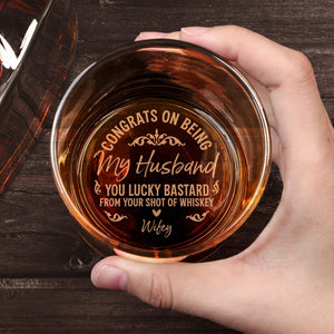 Top view of a Personalized Whiskey Glass held in hand engraved with congrats on being my husband message from wifey