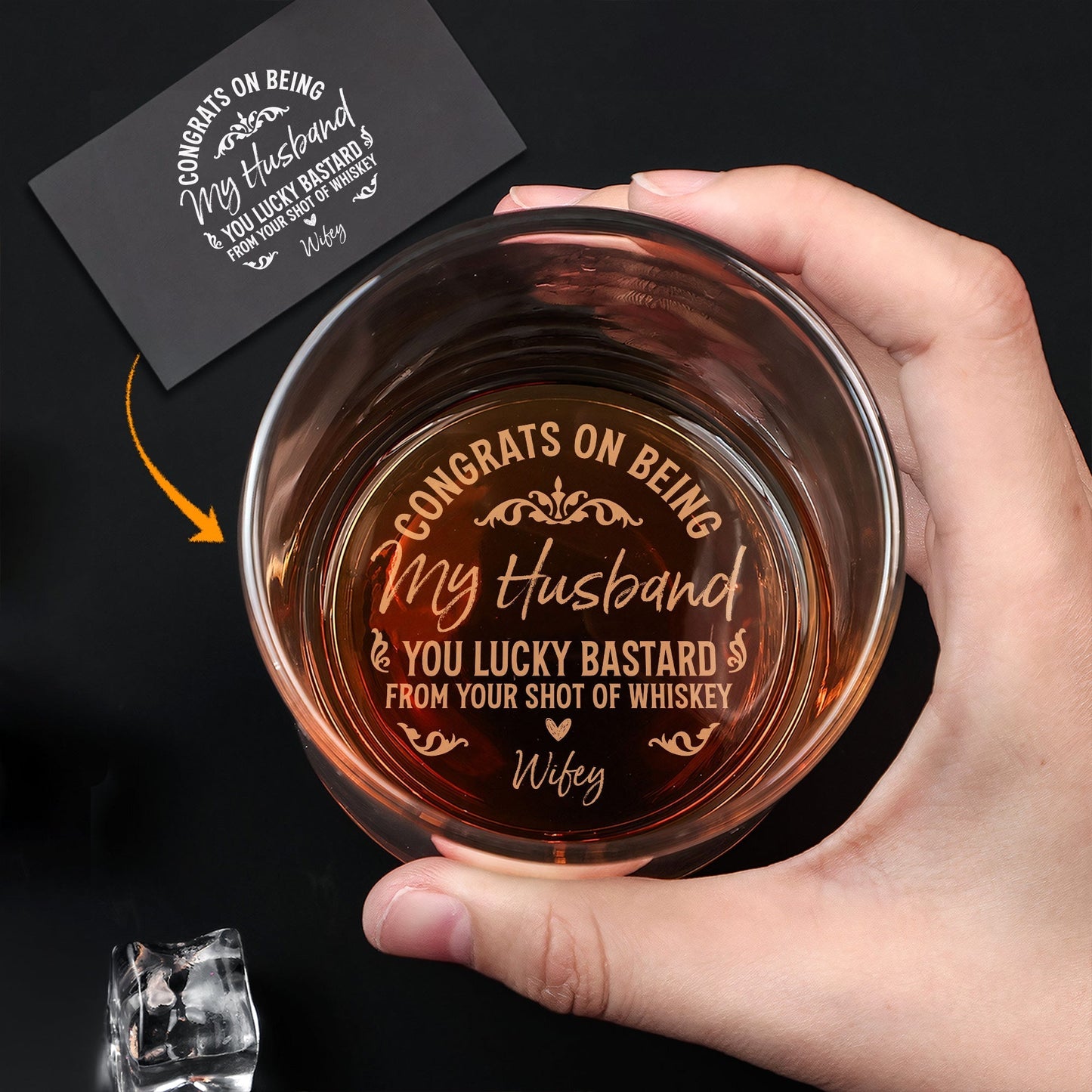 Hand holding Personalized Whiskey Glass showing engraved Congrats on being my husband message inside