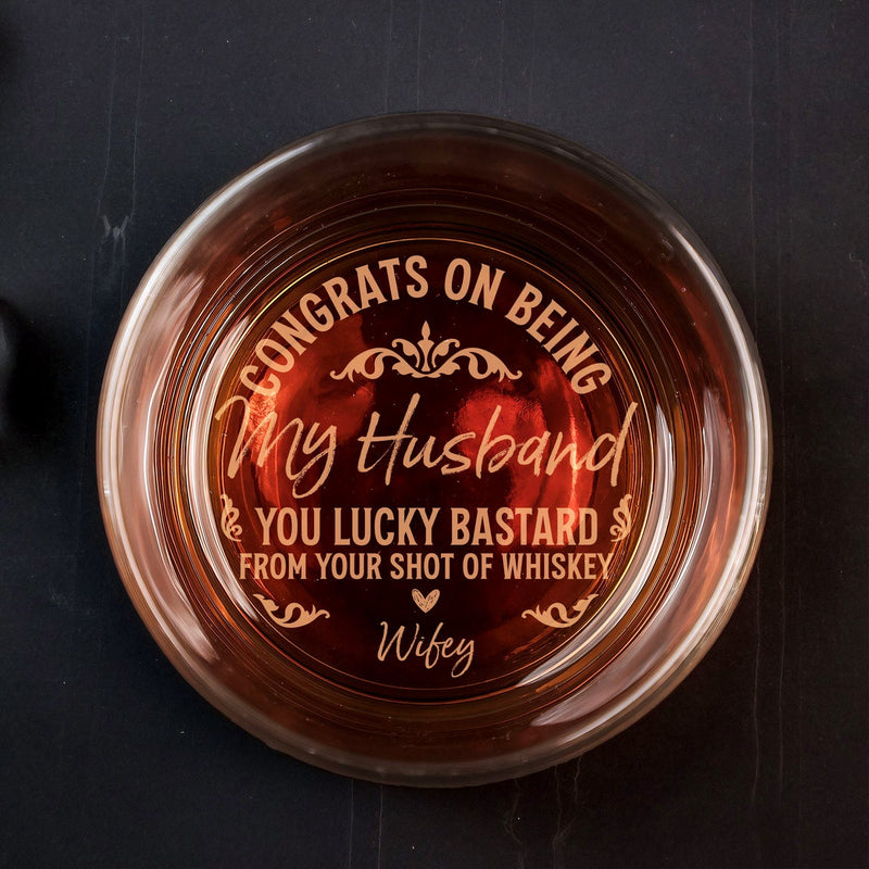 Top view of engraved Personalized Whiskey Glass with Congrats on being my husband you lucky bastard message from Wifey