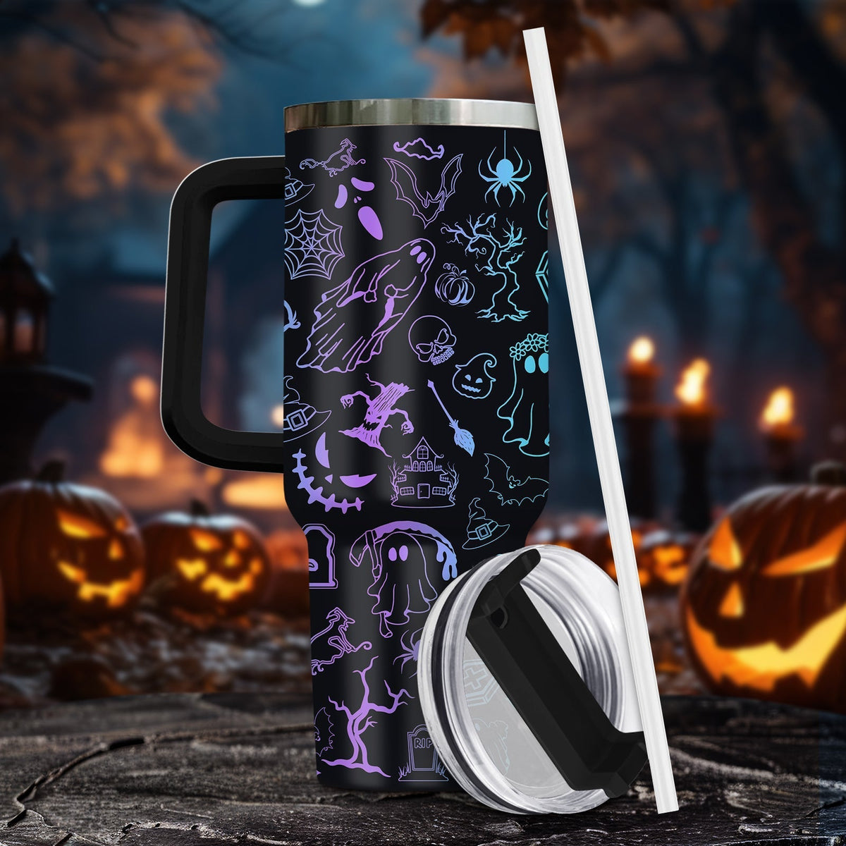Halloween tumbler with handle featuring spooky ghost and pumpkin designs, clear lid, and straw