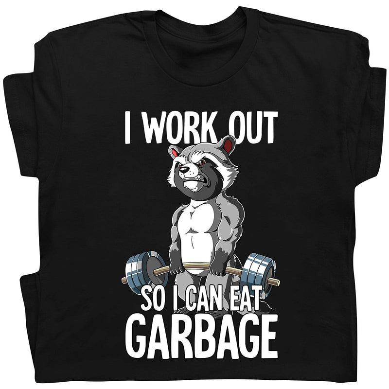 Black t-shirt featuring humorous workout apparel with a muscular raccoon lifting weights and text I work out so I can eat garbage