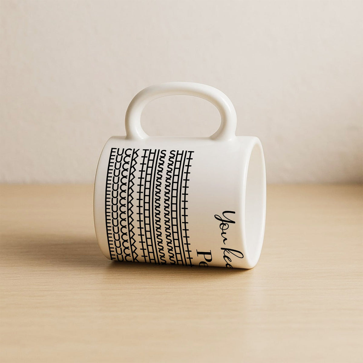 White ceramic personalized 'You Keep Me Sane' mug with black pattern and rounded handle on wooden surface