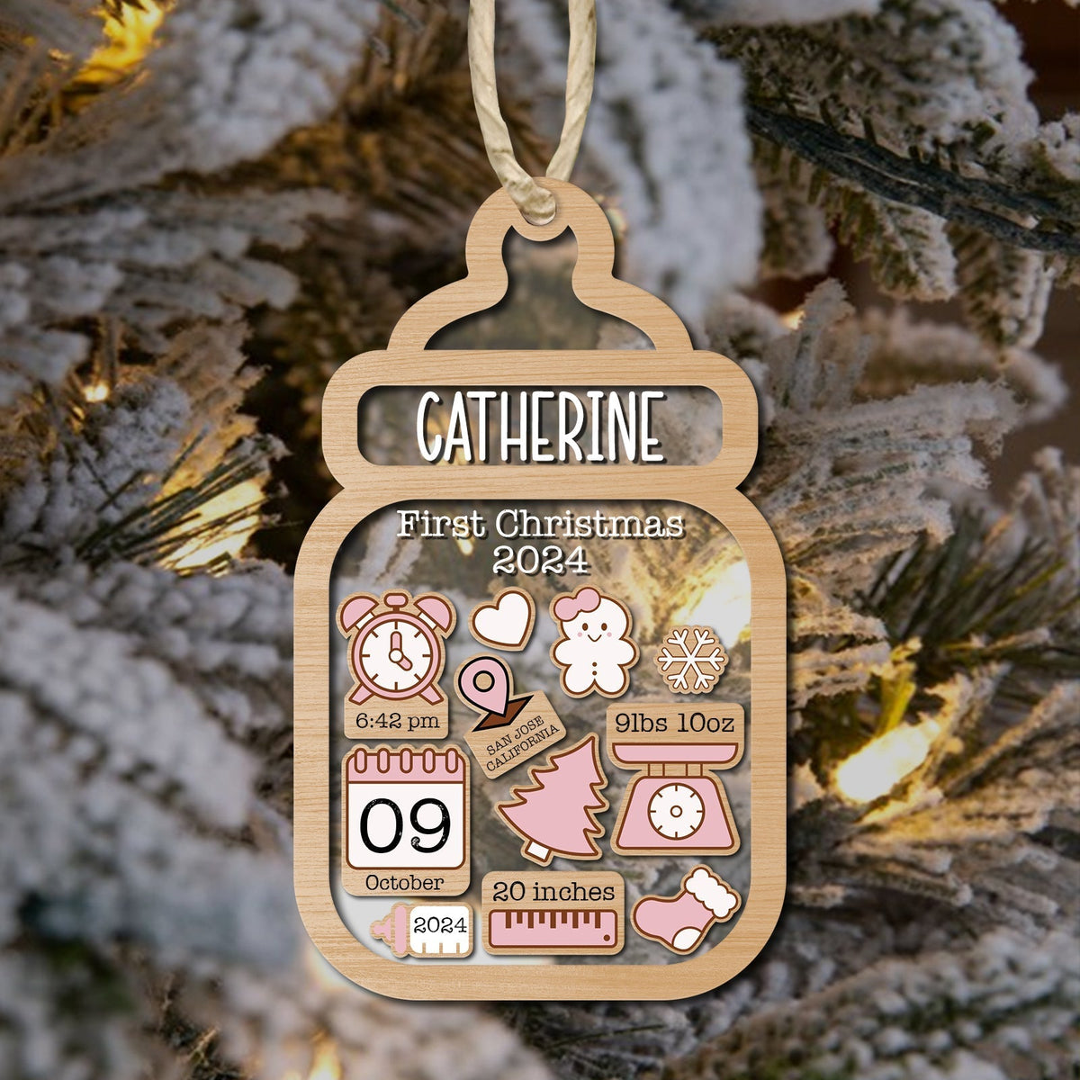 Personalized baby first Christmas ornament shaped like a baby bottle with name Catherine and birth details