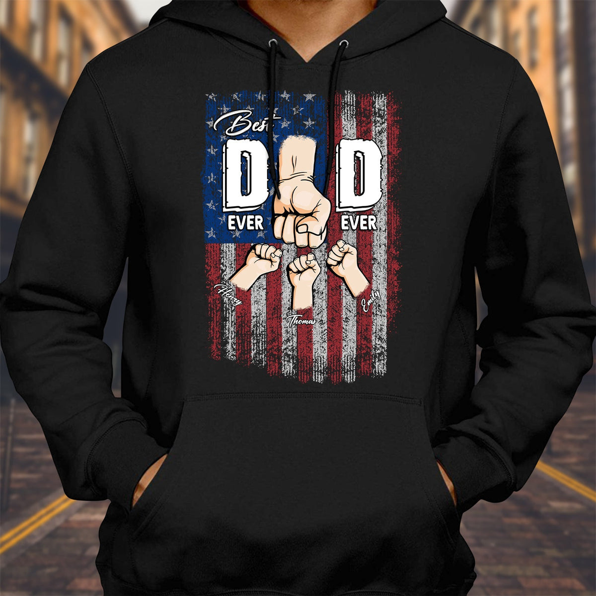 Black hoodie featuring a personalized best dad ever shirt design with fists bumping over an American flag background