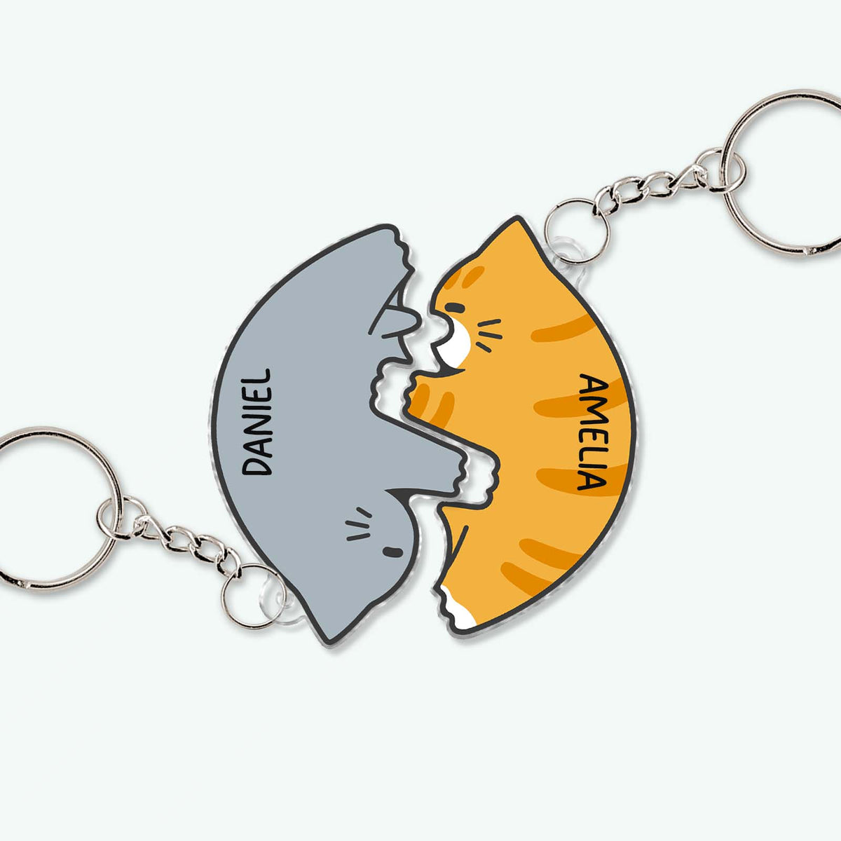 Personalized couple keychain set featuring matching gray shark and orange cat with names Daniel and Amelia