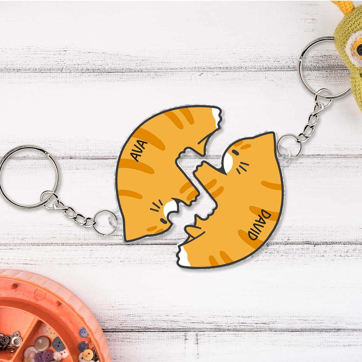 Personalized couple keychain set featuring two orange cat halves with names Ava and David