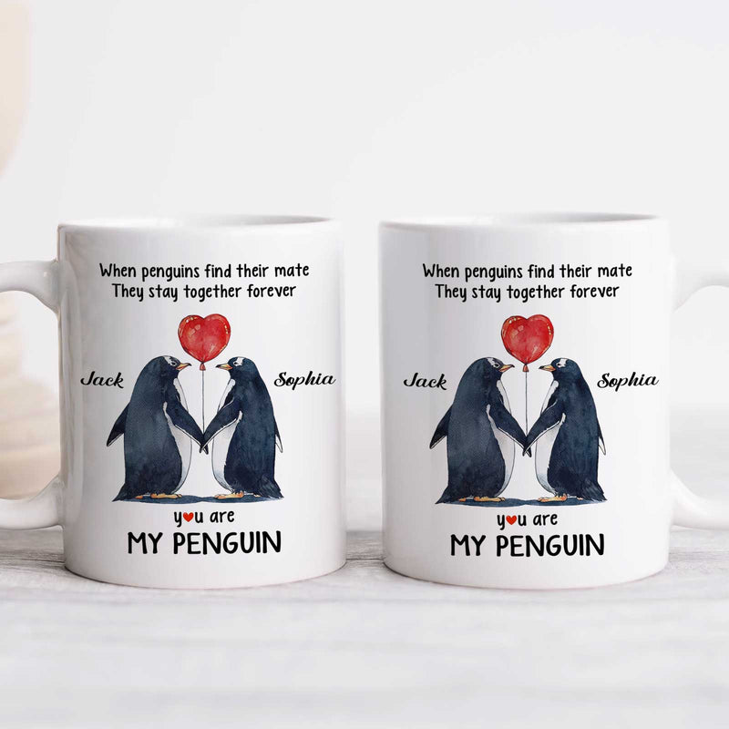 Personalized couple mug featuring two penguins holding a heart and custom names for a unique gift