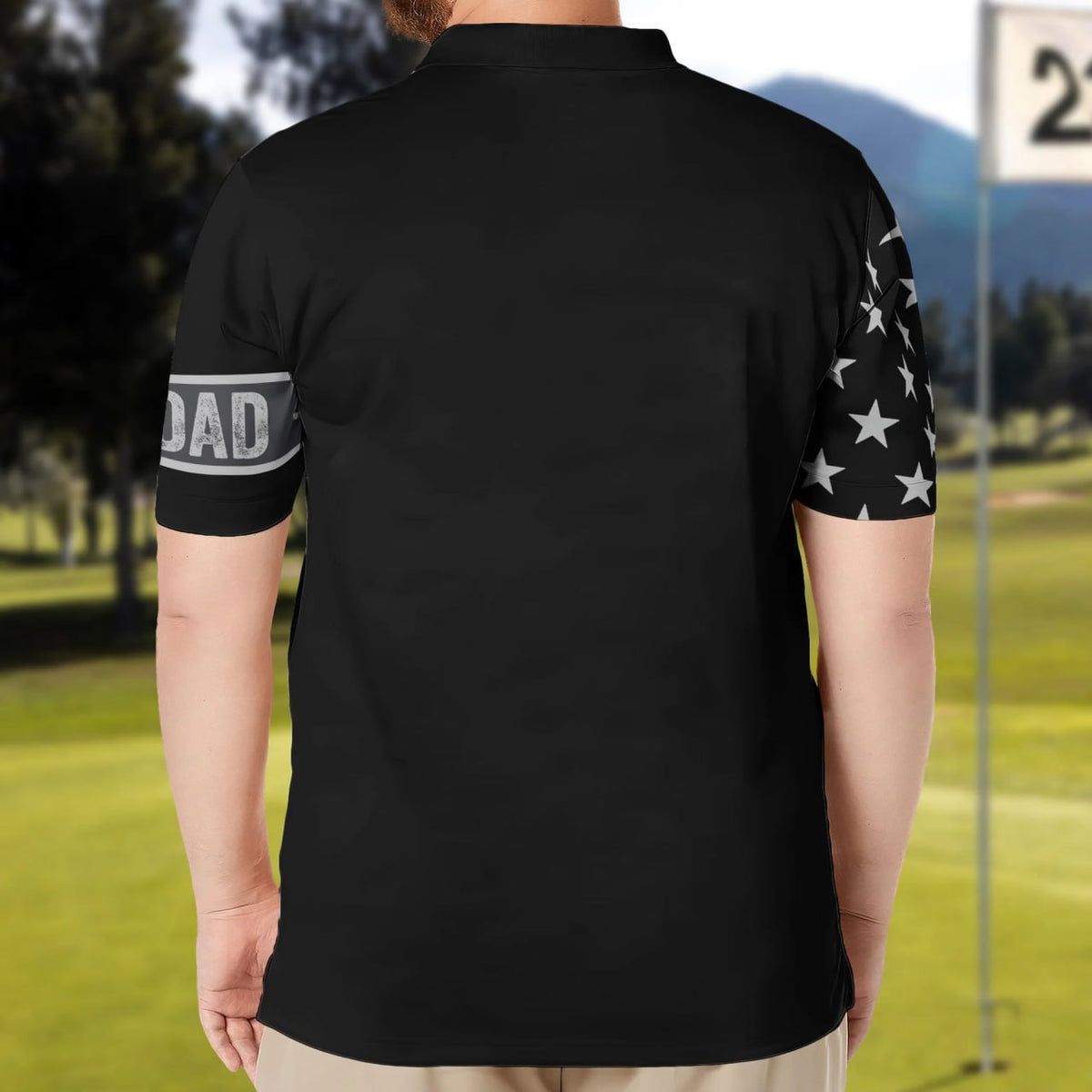 Back view of personalized dad polo shirt in black with star pattern on sleeve and dad text on arm