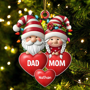 Personalized family Christmas ornament featuring Santa and Mrs. Claus with red hearts and custom name