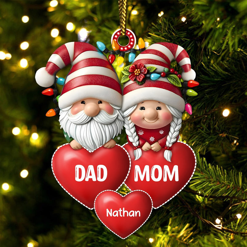 Personalized family Christmas ornament featuring Santa and Mrs. Claus with red hearts and custom name