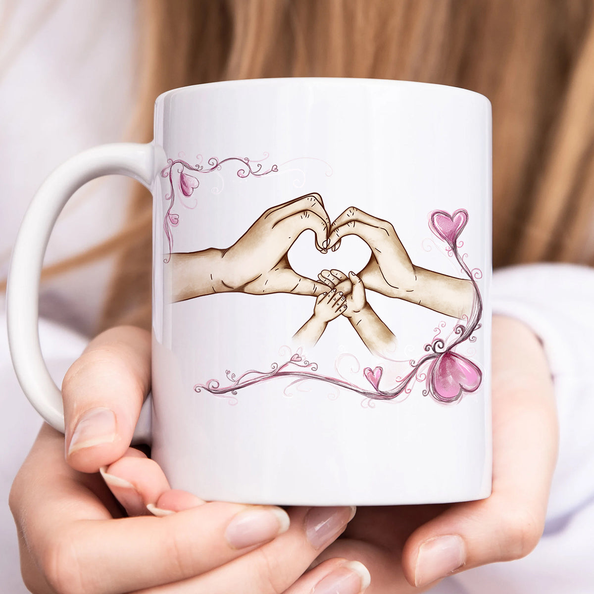 Personalized family mug featuring hand illustrations creating a heart shape with pink accents