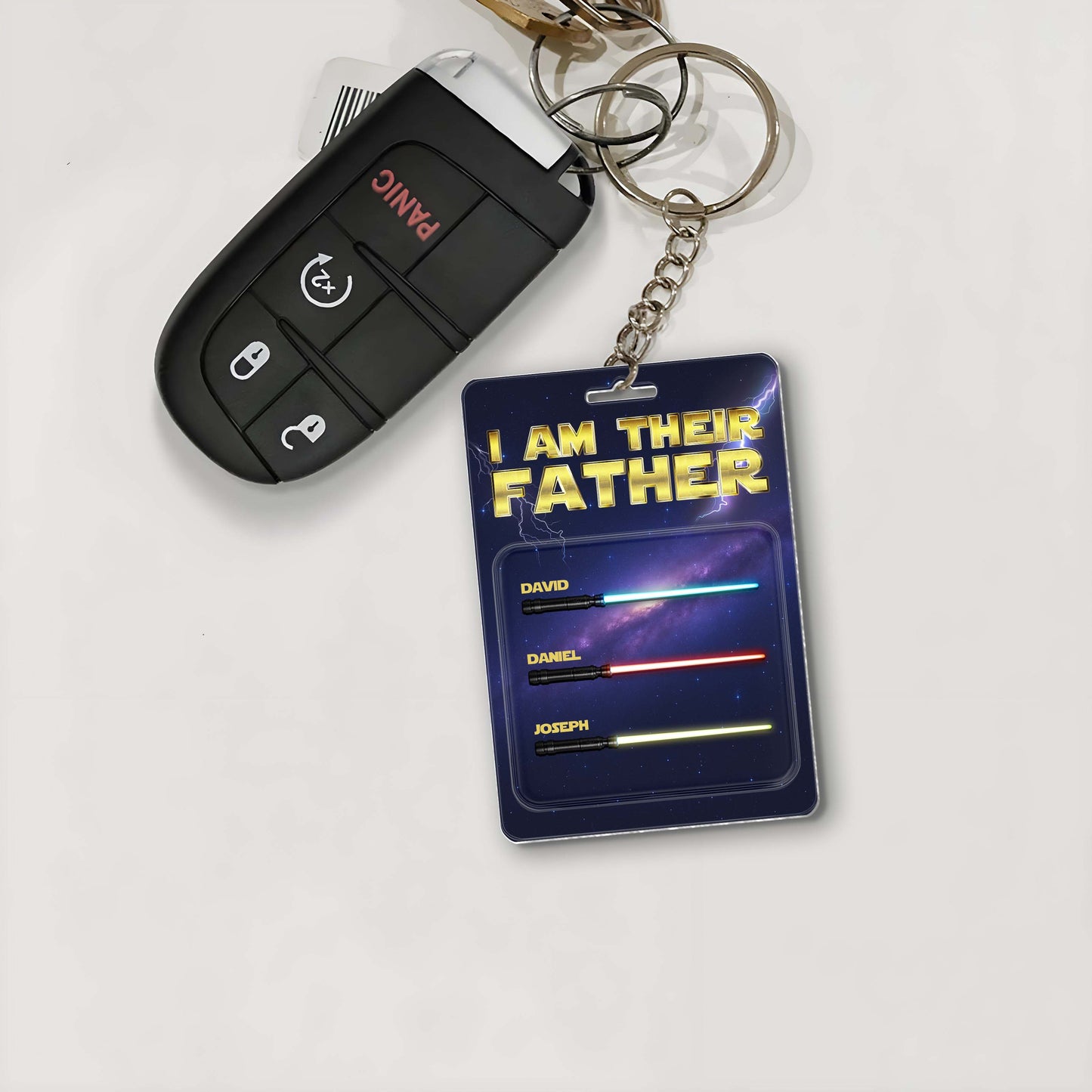 Personalized father keychain with names and a galaxy design attached to car keys