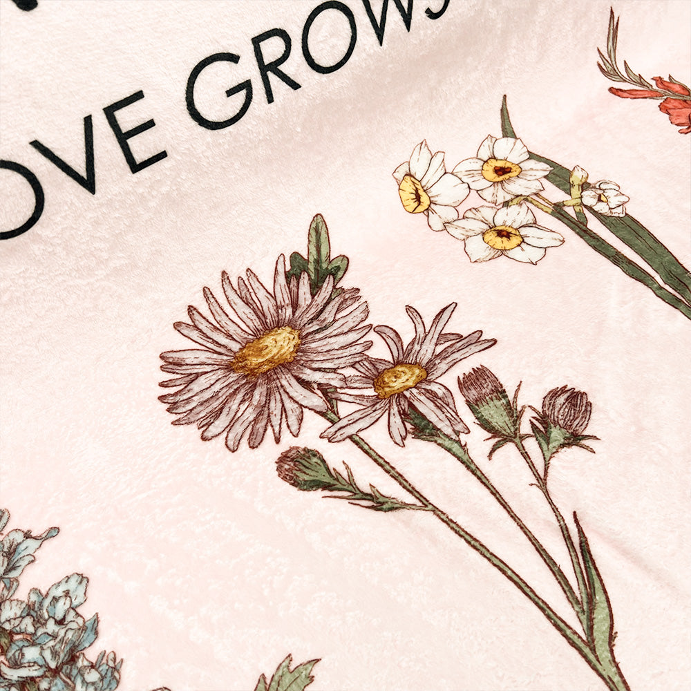 Personalized mom blanket with floral design and the quote Love Grows Here