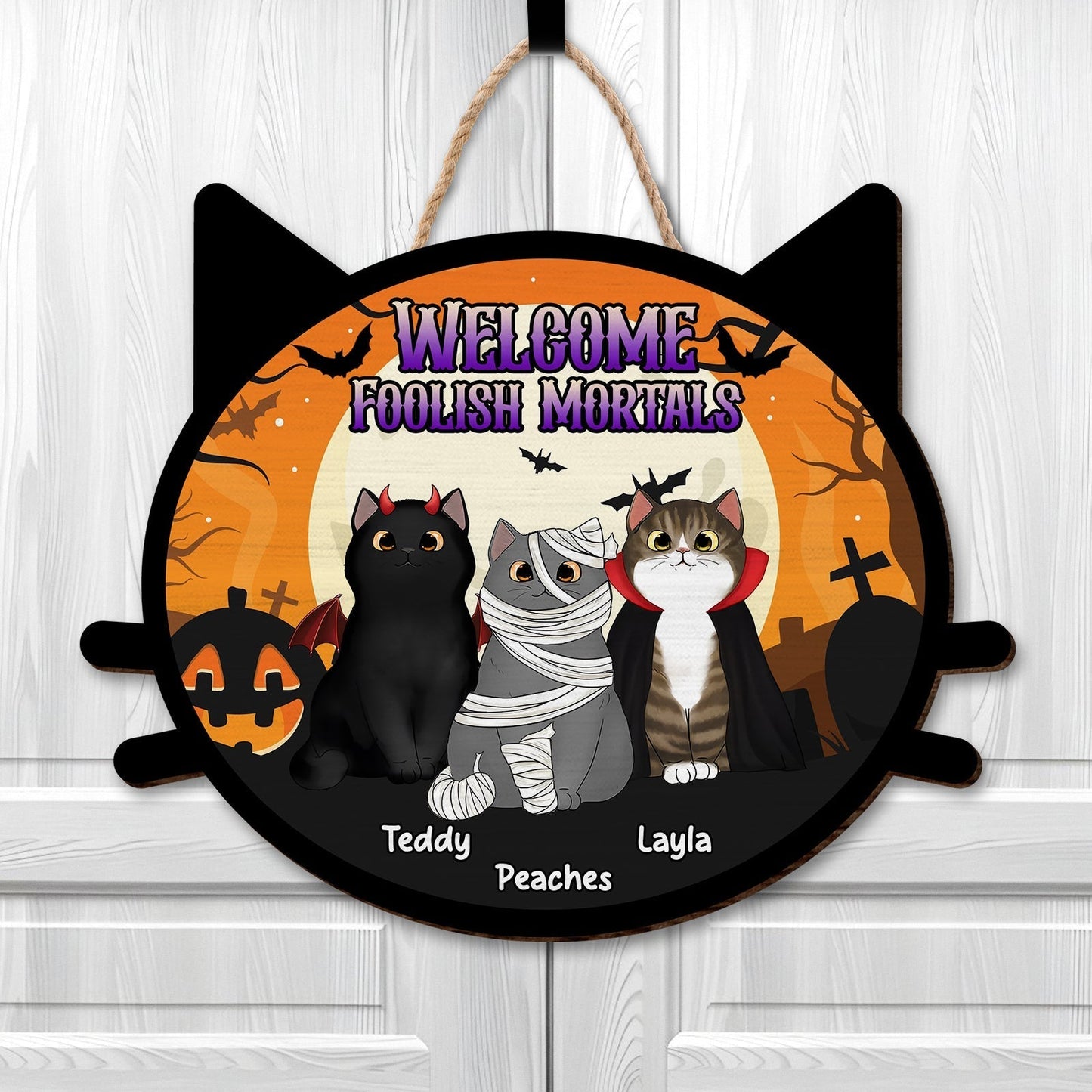 Personalized pet door sign featuring three playful cats in Halloween costumes with spooky background