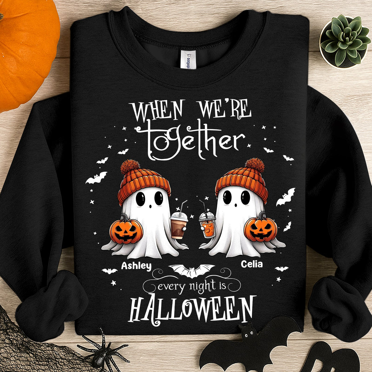 Black sweatshirt personalized Halloween ghost shirt with two ghosts in orange knit hats holding pumpkins and names