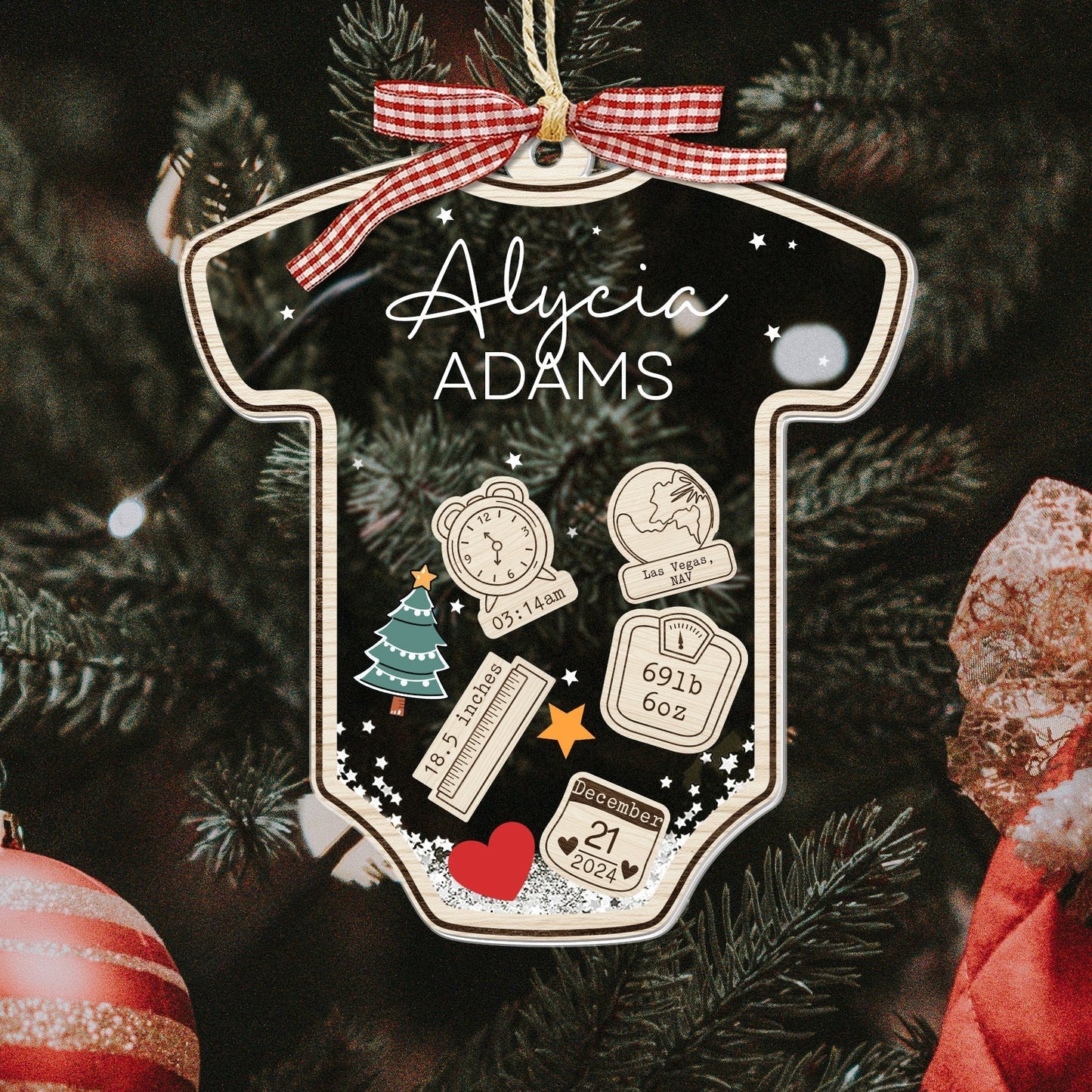 Personalized baby's first Christmas ornament shaped like a onesie with name Alycia Adams and birth details