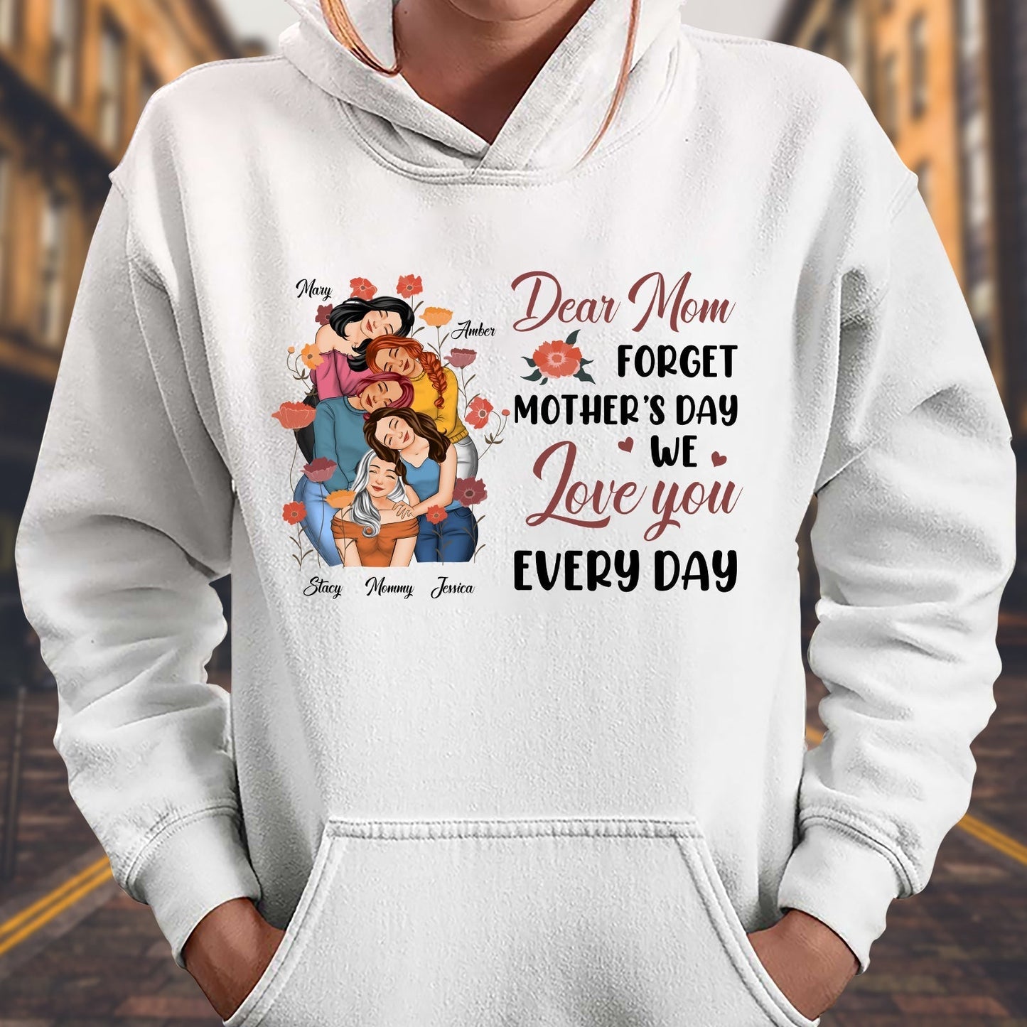 White hoodie featuring the phrase we love you every day mom tee with colorful floral design